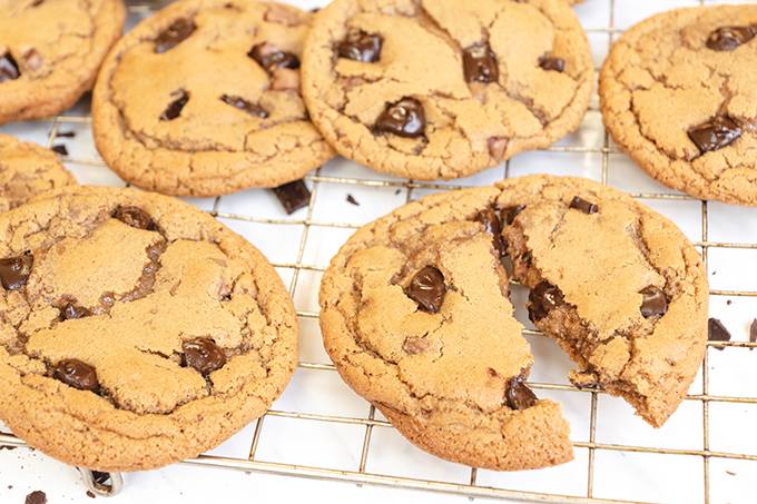 Chocolate chip cookies laid out on a wire cooling rack