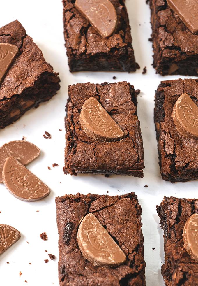 Top down view of 7 chocolate orange brownies and some extra mini segments of Terry's chocolate orange