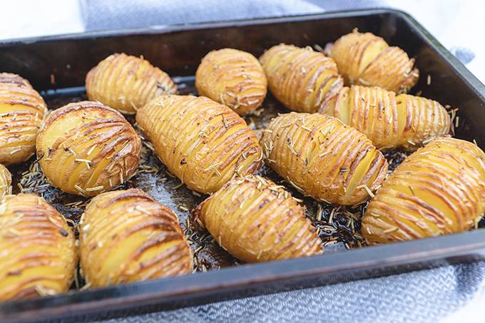 A tray of roasted hasselback potatoes