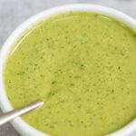 Pinterest graphic with text and a photo of spinach and walnut pesto