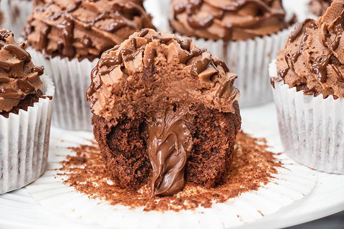 Close up of a gluten free nutella filled cupcakes, cut in half to reveal the nutella centre.