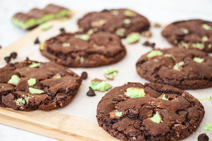 Aero mint chocolate chip cookies laid out on a wooden board.