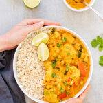 Pinterest graphic with text and a photo of cauliflower and chickpea curry