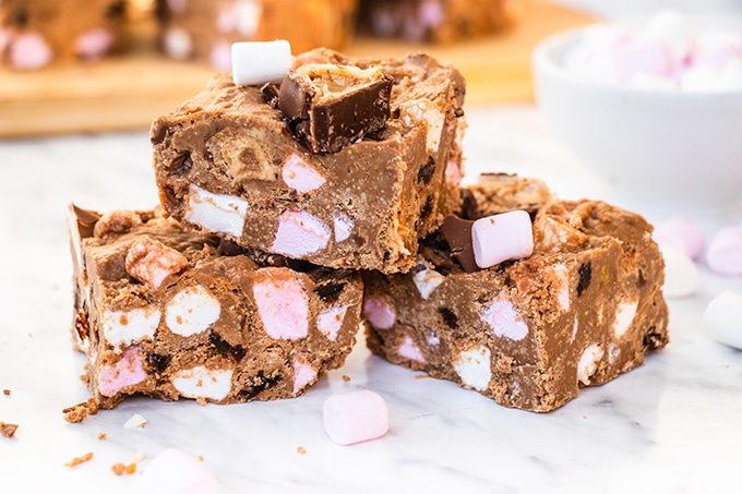 Close up of three Kinder rocky road bars with mini marshmallows scattered around them.