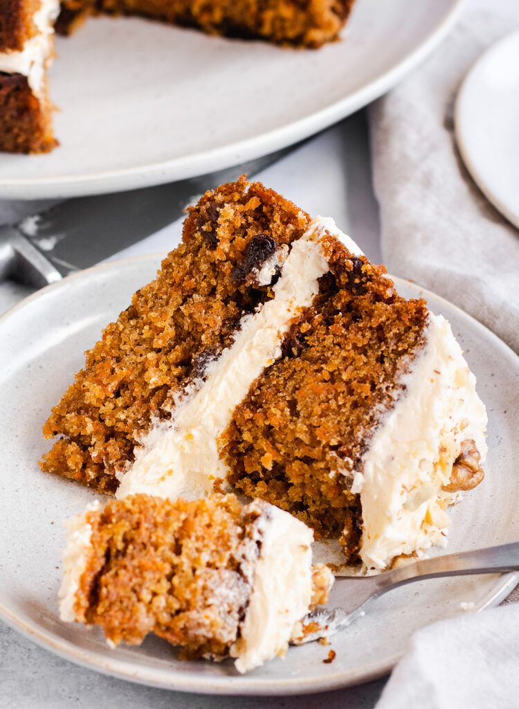 Close up of a slice of dairy free carrot cake on a plate.