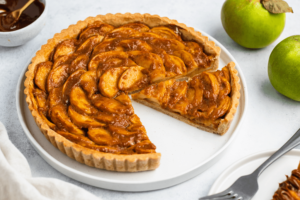 A gluten free caramel apple tart on a plate