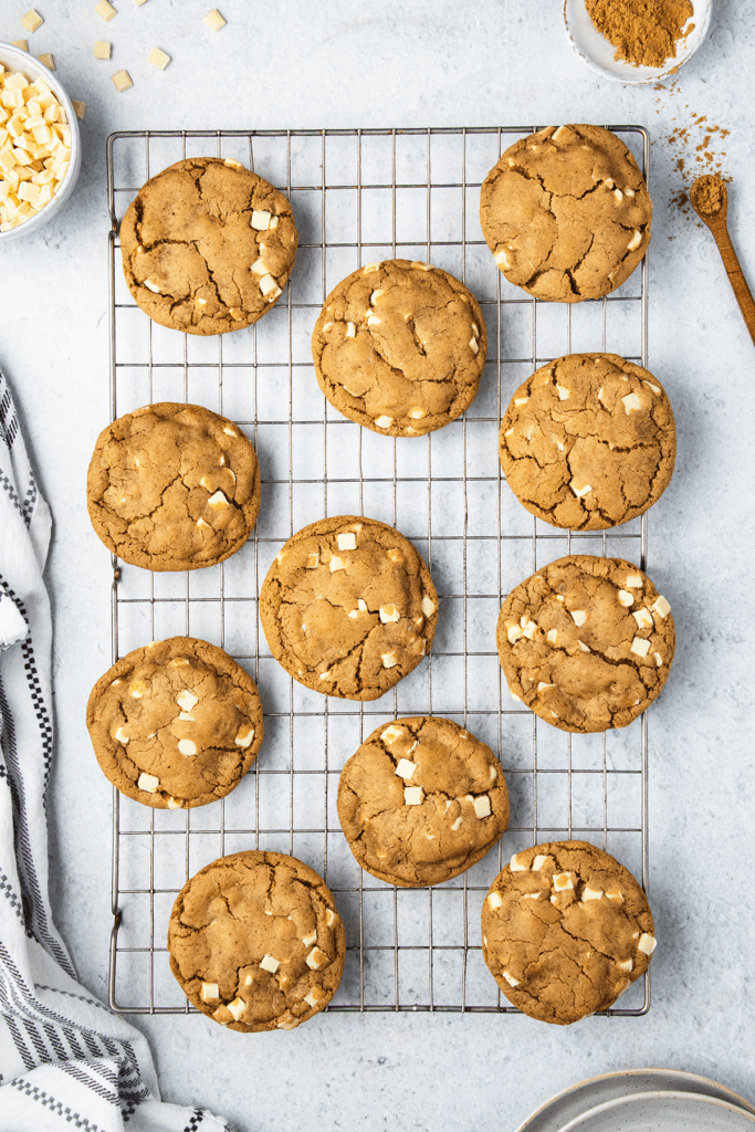 White chocolate and ginger cookies on a wire cooling rack