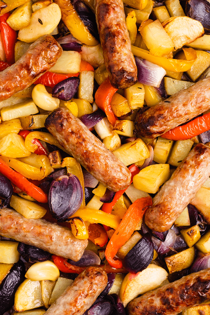 Close up of a sausage and veg tray bake