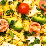 Pinterest pin graphic with text and a photo of chicken avocado pasta
